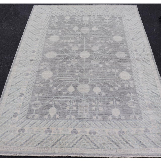 Measures: 5'9 x 8'7 Modern Khotan Rug with Subtle Gray Tones and Ivory Botanical Patterns 5'9 x 8'7. Keivan Woven Arts;...