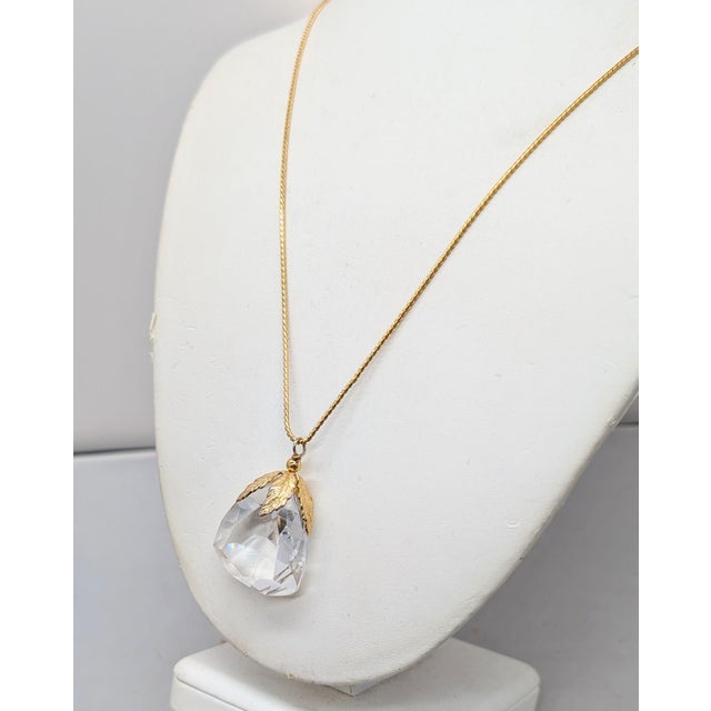 1960s goldtone faceted pear shaped glass pendant with goldtone leaves around the top on a thin chain with spring ring...
