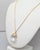 1960s goldtone faceted pear shaped glass pendant with goldtone leaves around the top on a thin chain with spring ring...