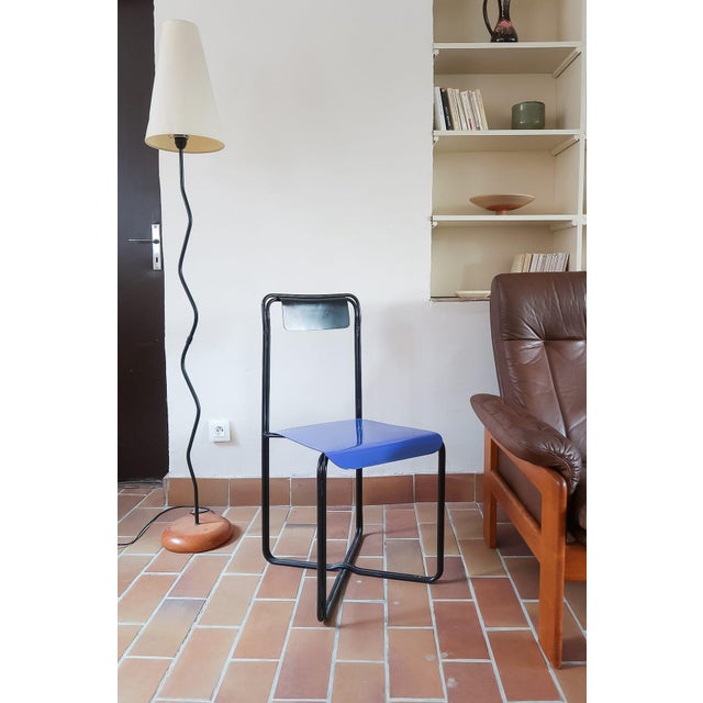 Kaa chair designed by Francesco Soro, Italian design of the 1980s. Entirely in lacquered metal: a single bent black tube...