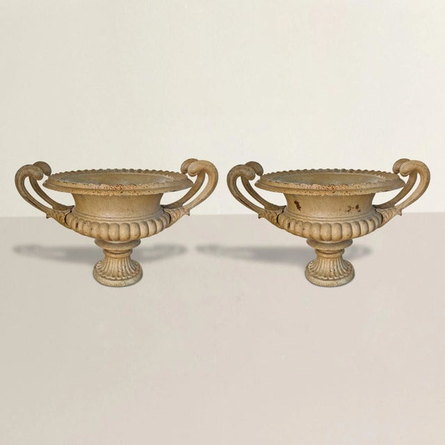 These magnificent 20th-century American cast iron garden urns exude timeless elegance and charm with their neoclassical...