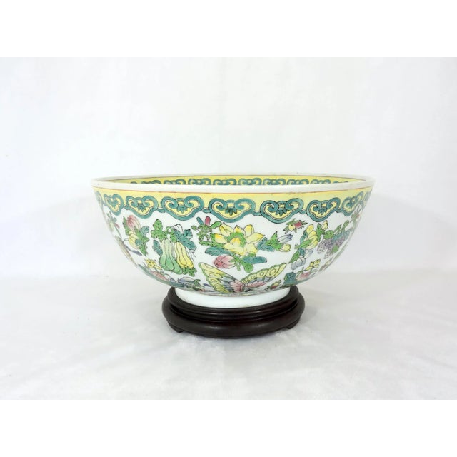 A large Chinese export bowl profusely hand painted throughout with richly applied and colourful enamels. Exotic...