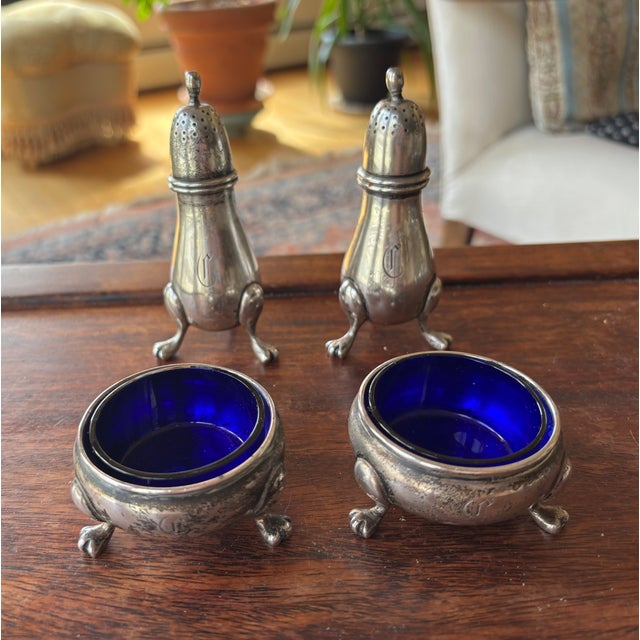 Two Charming early 20th-century Sterling silver figural salt and pepper shakers, accompanied by a matching set of open...