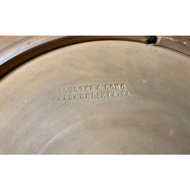 The antique 19th century hand painted Coulter & Long pottery charger is a rare and valuable piece of early terra-cotta....