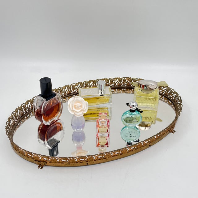 This elegant vintage tray features a beautifully detailed brass filigree gallery edge paired with an elongated oval-shaped...