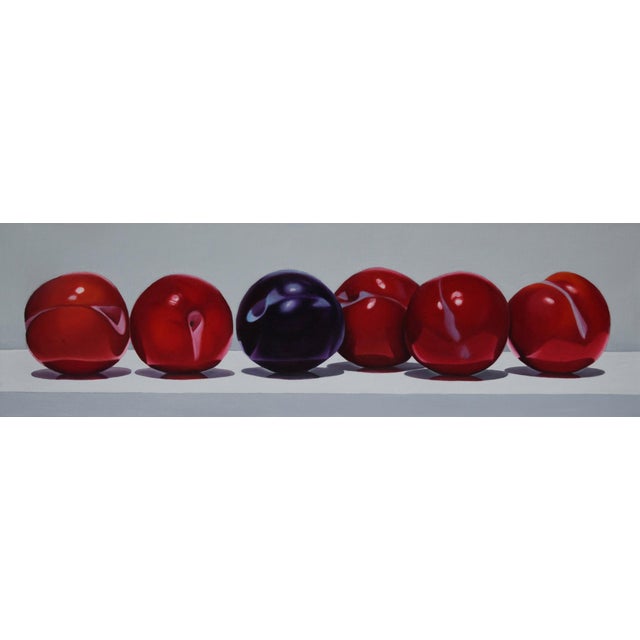 This oil on canvas artwork features a row of plums, with one distinct blue plum among a series of rich red ones. The...