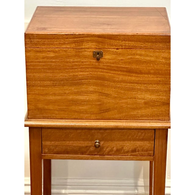 A distinguished mahogany humidor cabinet by Alfred Dunhill, designed to combine refined craftsmanship with practical cigar...