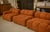 A large modular sofa seating approximately 10 people, composed of juxtaposed elements to create a very generous...