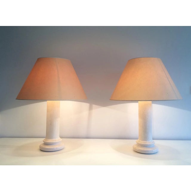 This pair of lamps is made of a white cracked earthenware. This is a French work, circa 1970. Delivery can be less...