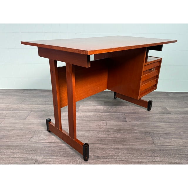 This mid-century Italian teak desk, dating back to the 1960s, showcases the refined aesthetic typical of that era. The...