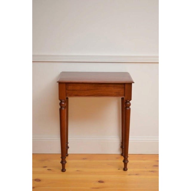 An elegant English mid-19th-century mahogany hall table of exceptionally rare, narrow proportions. Crafted circa 1850,...