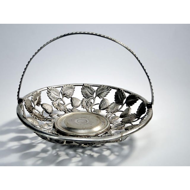 Fruit basket produced around 1900-1915 in Warsaw by the Fraget factory. It was made of white plated metal. It is preserved...