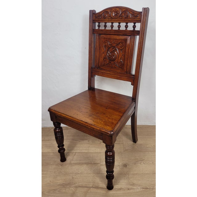 This charming 19th Century kitchen chair shows beautifully handcrafted, intricate carved details from the Victorian Era....