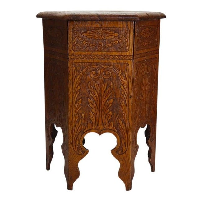 An antique Arts & Crafts hexagonal tabouret plant stand crafted from oak, dating to approximately 1920. This piece...