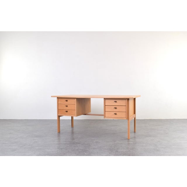 This oak desk was designed in the 1960s by Danish designer Svend Åge Madsen and manufactured by the Sigurd Hansen...