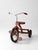 A vintage American Machine and Foundry “Junior” tricycle in its original red finish, dating to the late 1950s–early 1960s....