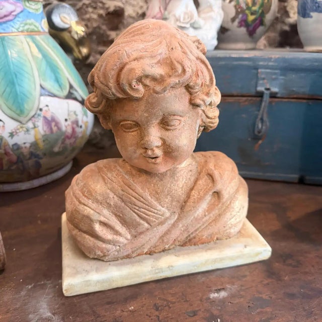 This charming 1930s Sicilian sculpture depicts a classic putto, radiating the whimsical and serene character typical of...