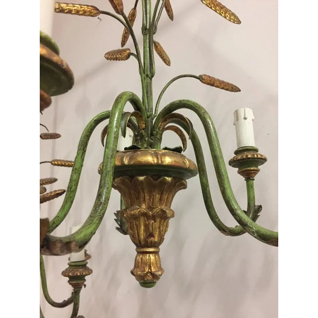 1960s 5-light metal and wood chandelier lacquered green and gold. European Plug (up to 250V).The wiring of this item may...