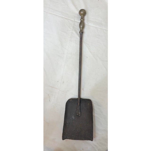 Up for sale is a rare antique 18th century wrought iron and brass English fireplace shovel. The shaft and blade are...