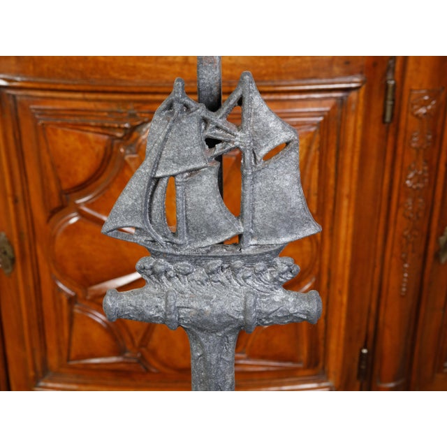 A pair of iron vintage table lamps from the mid 20th century, depicting anchors and sailboats. Created during the second...