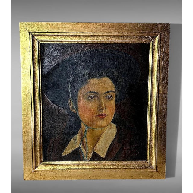 Refined Italian oil on canvas portrait dated 1943, depicting a young elegantly dressed woman captured in a moment of quiet...