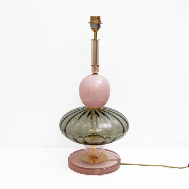 Pair of elegant table lamps crafted in Murano glass in soft pink and green tones, enriched with refined brass details. The...