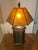 This vintage Arts and Crafts style table lamp, distinguished by its prominent amber mica paneled shade and an octagonal or...