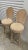 A striking pair of vintage bar stools featuring sculptural shell-inspired backs and gently curved legs. The carved frames...