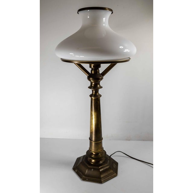 We are selling this stylish 1970s brass table lamp by Ethan Allen. This table lamp has Sinumbra Astral lamp form with faux...