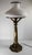 We are selling this stylish 1970s brass table lamp by Ethan Allen. This table lamp has Sinumbra Astral lamp form with faux...