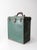 This early 20th-century industrial utility tool box features a green painted exterior, riveted steel corner guards, aged...
