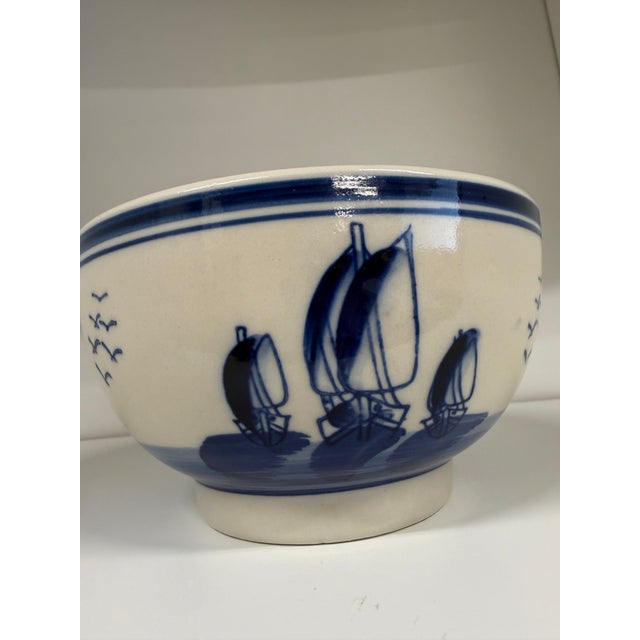A charming vintage Delft Blue bowl dating to the 1950s, beautifully decorated with classic Dutch-inspired scenes in a rich...