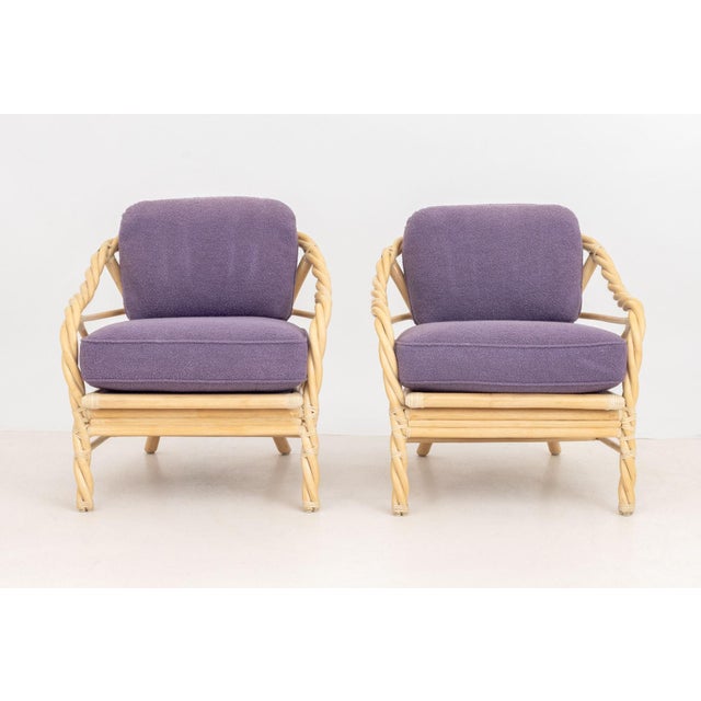 Pair of McGuire Twisted Rattan Arm Chairs, with purple upholstered cushions and "McGuire" label to underside. 31.5" H x...