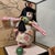The doll has a calm, refined expression, long black hair, and wears a richly woven kimono with soft floral motifs. Display...