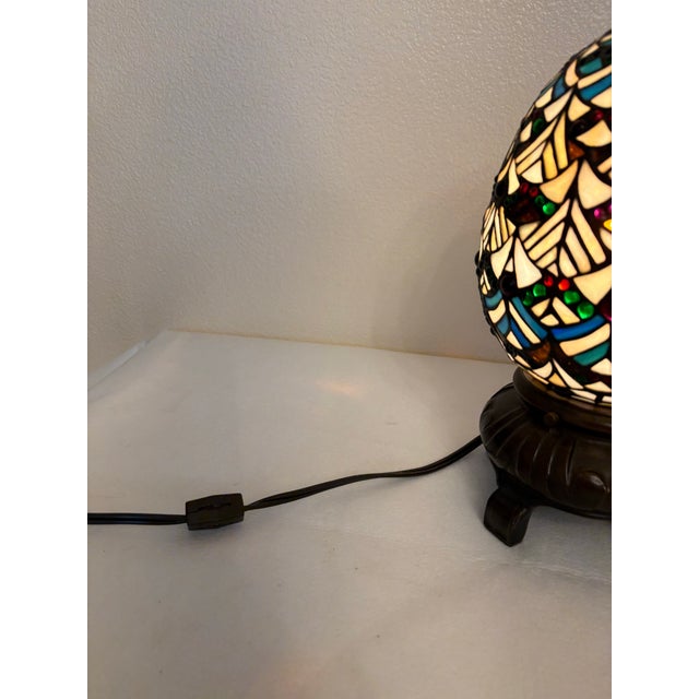 Beautiful vintage Tiffany style accent lamp featuring an iconic egg-shape shade. Hand-crafted with a brilliant mosaic...