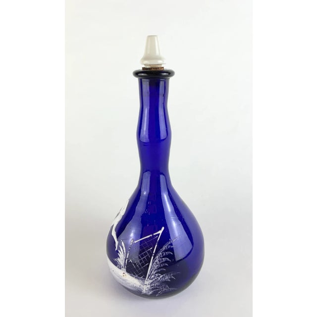 This gorgeous royal blue bottle will make a stunning display in any bar, restaurant or home collection. Attributed to Mary...