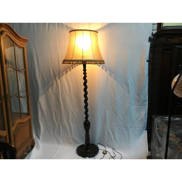 Wooden lamp standing on a screw column. The lampshade is made of pig skin damaged in one place 15cm as shown in the...