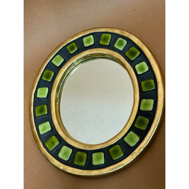 Crackle-glazed earthenware mirror in gold, green, and black. 28 cm in diameter I have official proof of authenticity such...