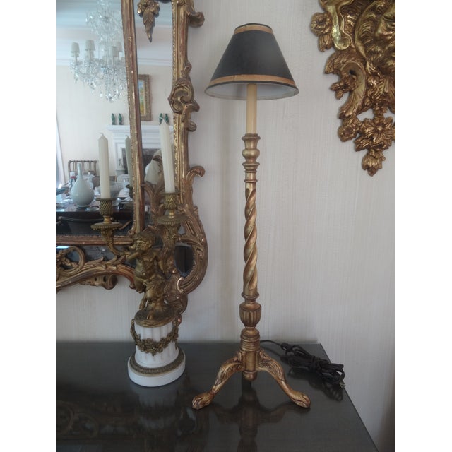 A wonderful pair of buffet candlestick style lamps form maitland smith in gold leaf.