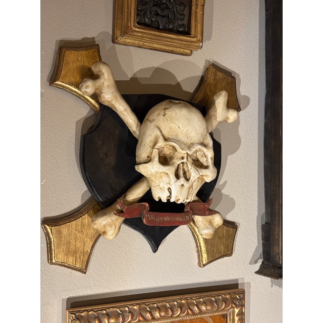 Rare hand sculpted, painted and parcel gilt skull and crossbones Memento Mori Style wall hanging sculptural object. The...