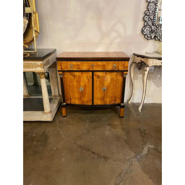 Very fine 19th century German Biedermeier Cherry wood cabinet with ebonized details. This piece has a beautiful wood grain...