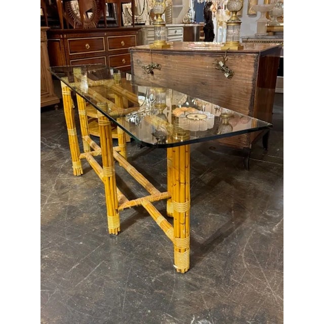 The Italian Bamboo Console with Glass Top is a stylish and modern furniture piece perfect for adding a touch of textural...