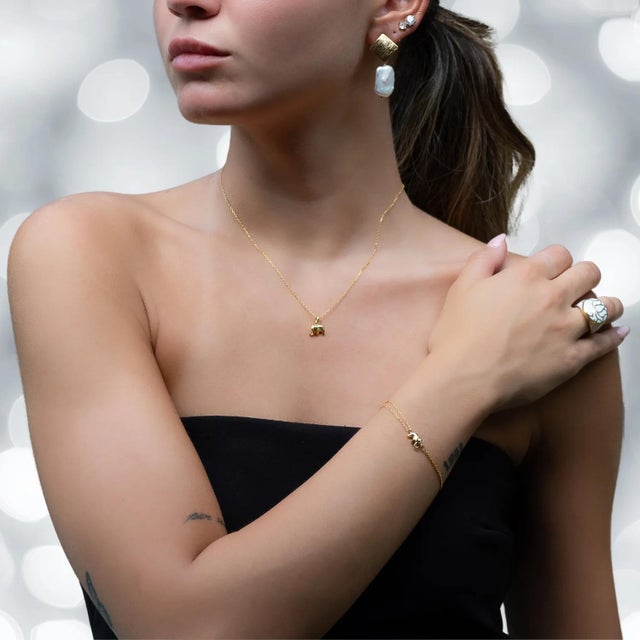 The Dainty Gold Lucky Elephant Bracelet is a captivating piece of jewelry that exudes grace and symbolism. The elephant...