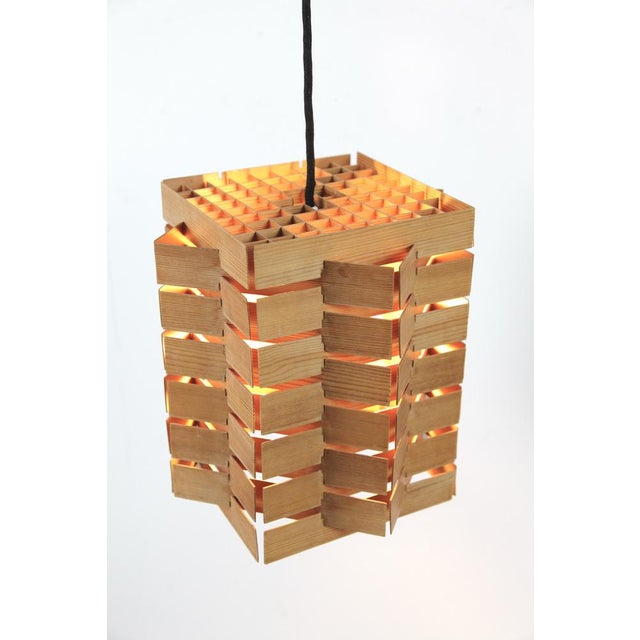 A uniquely crafted, delicate pendant lamp made of pine wood slats! it belongs to the spon series, model 7716, and was...