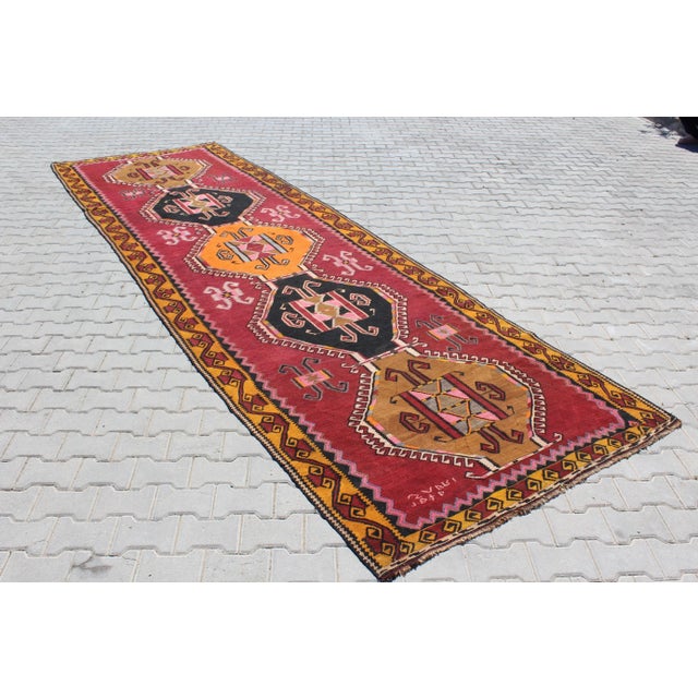Bring a piece of history into your home with this stunning handmade Turkish kilim runner, crafted in 1970. This vintage...