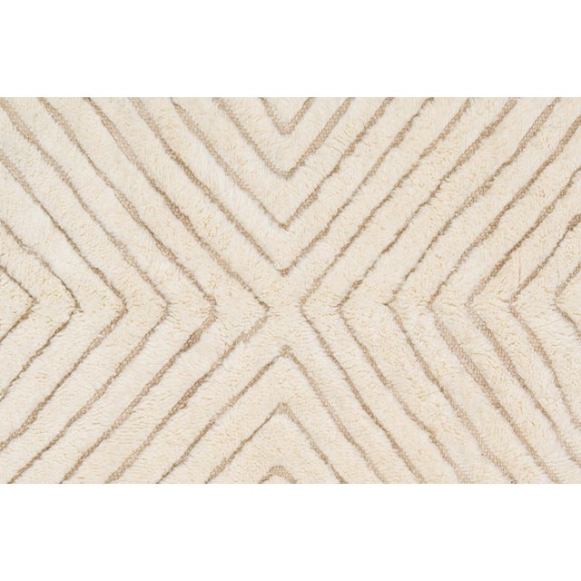 Elegant hand-knotted wool rug in Warm Taupe and Ivory, showcasing a striking chevron-inspired pattern with meticulously...