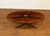 This oval coffee table features a booked-and-butted crotch mahogany top with a yew wood border and a medallion in the...