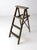 This vintage three-step wood folding ladder dates back to the early to mid-20th century. The green painted finish has...