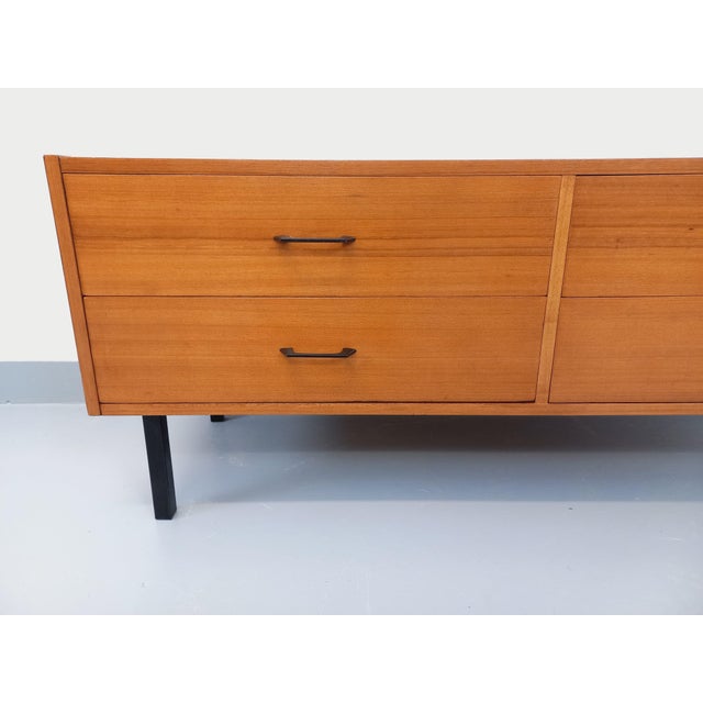 Small vintage sideboard or low chest of drawers in a Scandinavian modernist style from the 1960s, made of teak, with black...
