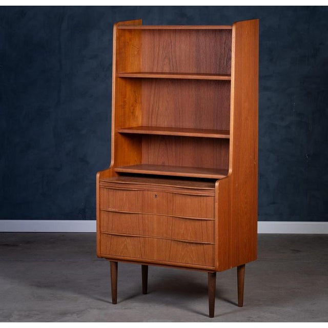 Beautiful Danish bookcase from the 1960s crafted in warm teak wood. Features three spacious drawers with elegant handles...